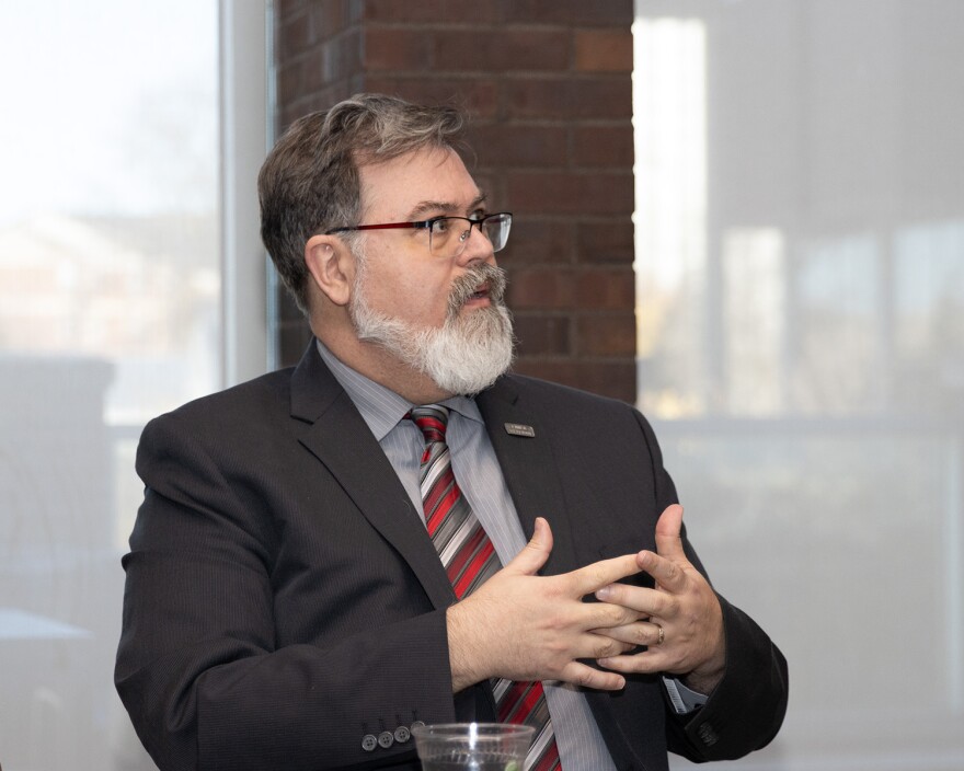 The man in the suit, Jess Ray, speaks at an ISU Veterans Day interview. 