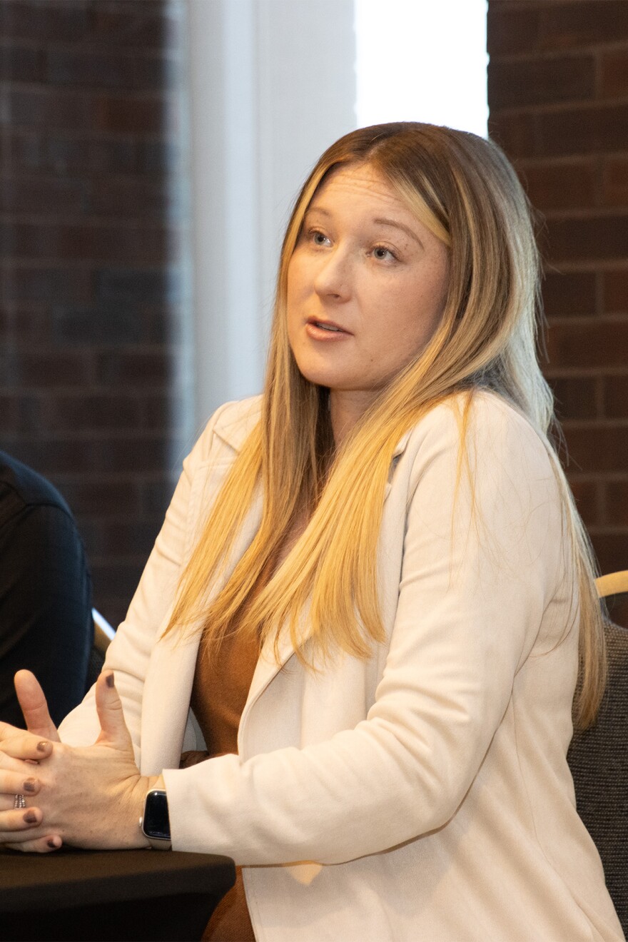 The woman in the white blazer, Alex Doup, speaks at an ISU Veterans Day interview.